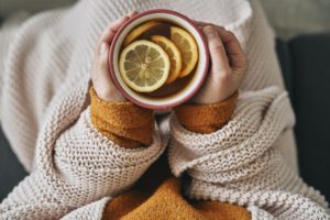 Top view of woman holding cup of hot tea